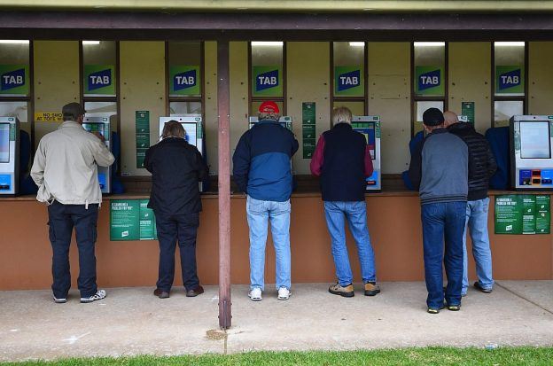 Bettors place wagers on races through TAB betting kiosks in Australia