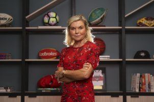 Entain CEO Jette Nygaard-Andersen poses with a bookcase of sports memorabilia
