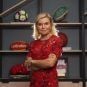 Entain CEO Jette Nygaard-Andersen poses with a bookcase of sports memorabilia