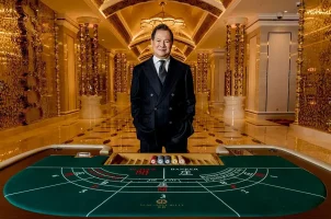 NagaCorp founder Chen Lip Keong stands behind a baccarat table at NagaWorld