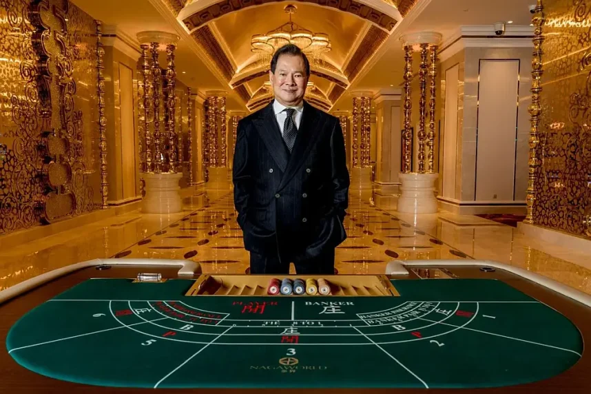 NagaCorp founder Chen Lip Keong stands behind a baccarat table at NagaWorld