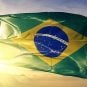 The Brazilian flag flying against a backdrop of the sun