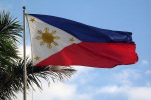 The Philippines flag flying on a pole on a sunny day