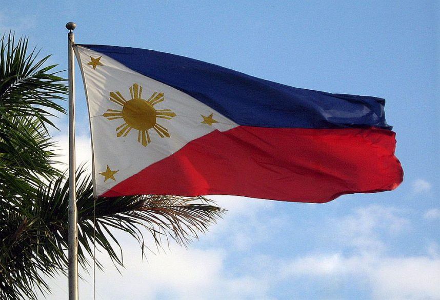 The Philippines flag flying on a pole on a sunny day