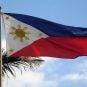 The Philippines flag flying on a pole on a sunny day