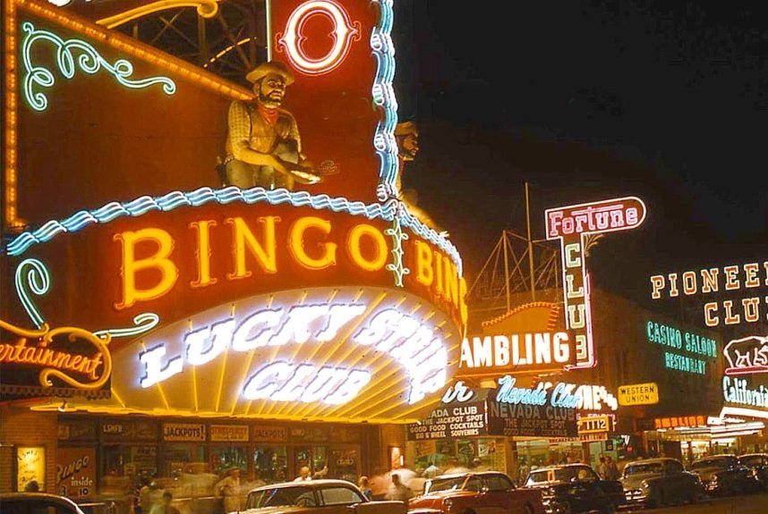 twin gold prospector statues kneel above the Lucky Strike Club sign