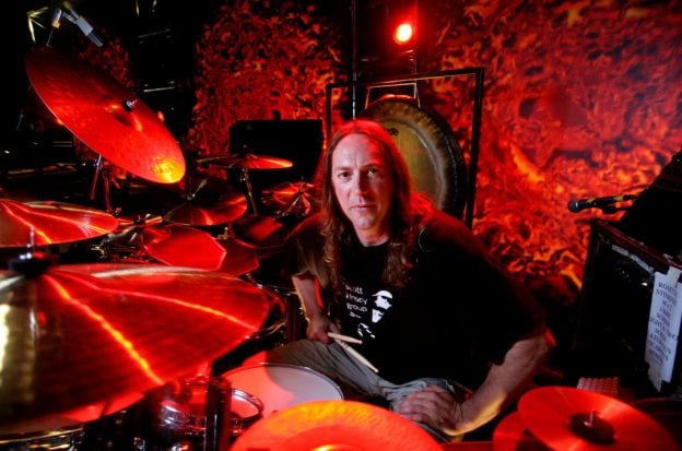 Danny Carey of Tool sitting at a drum kit