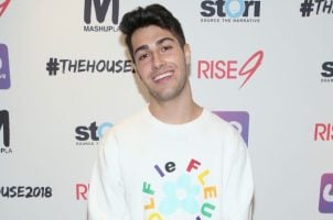 Gavin Caci in front of advertising