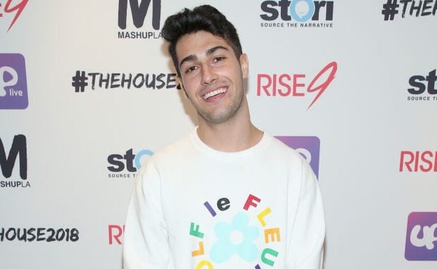 Gavin Caci in front of advertising