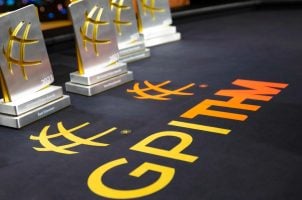 Global Poker Awards trophies sit on a poker table