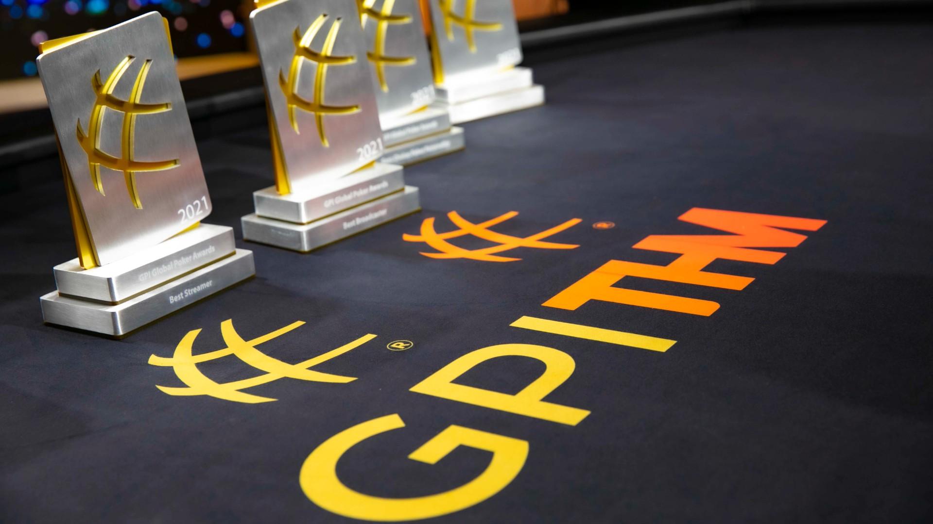Global Poker Awards trophies sit on a poker table