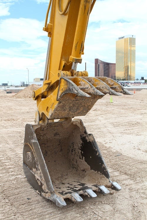 The "thumb" is on top, above the "bucket." We're all over this excavating business.