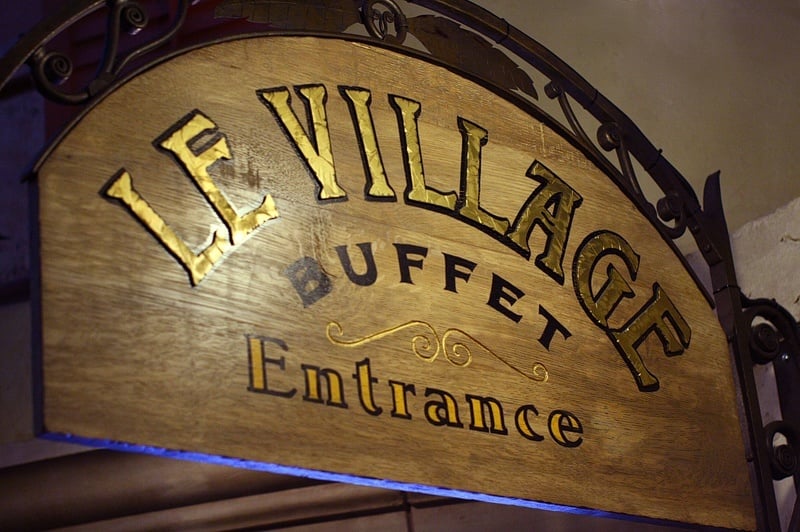 "Le Village" is French for "For your convenience, 'village' is the same in English and French."